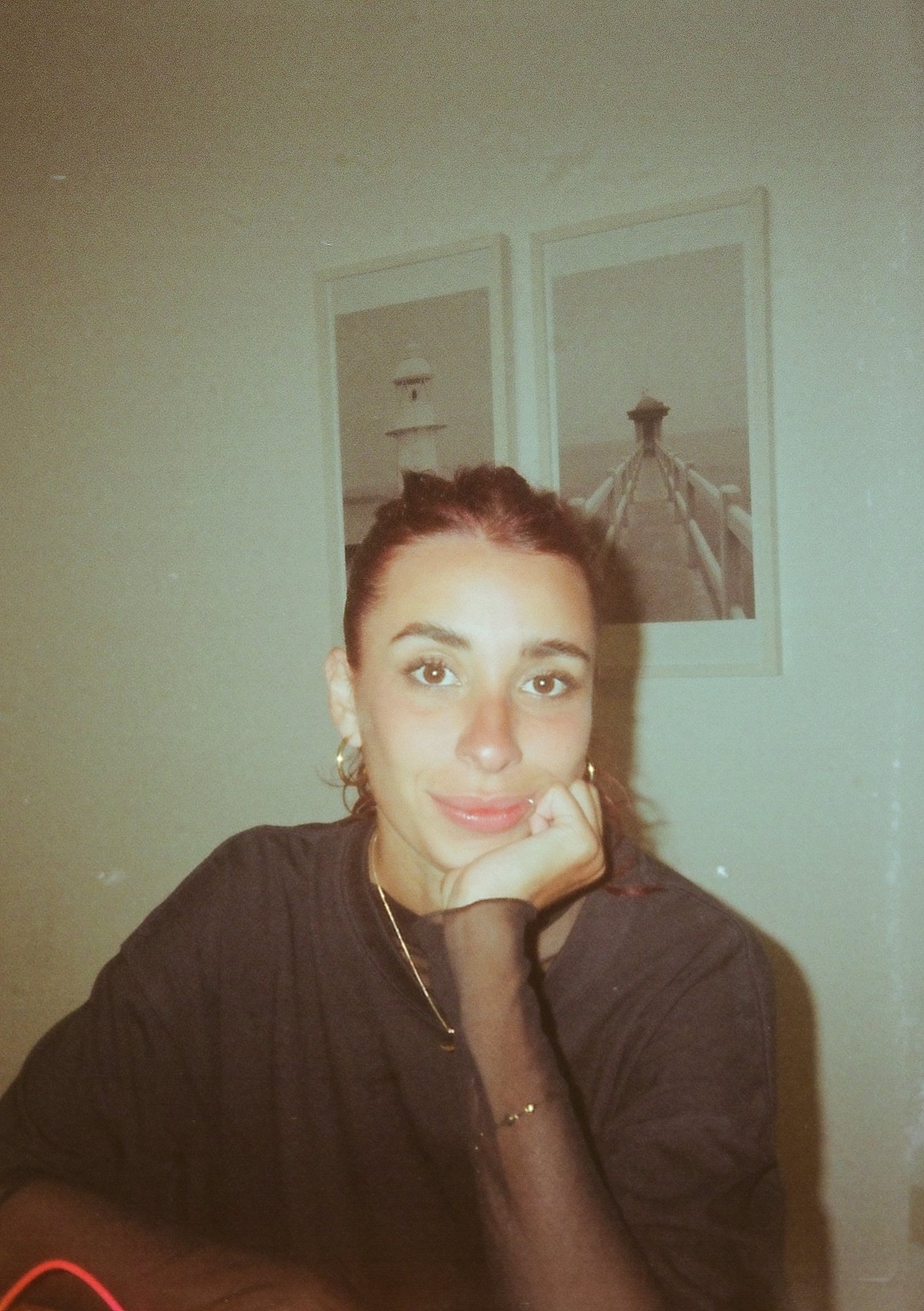 Portrait of Lucía resting her chin on her hand, shot on film