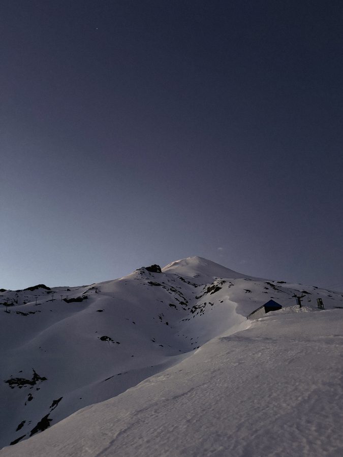 Snow slope and summit at blue hour